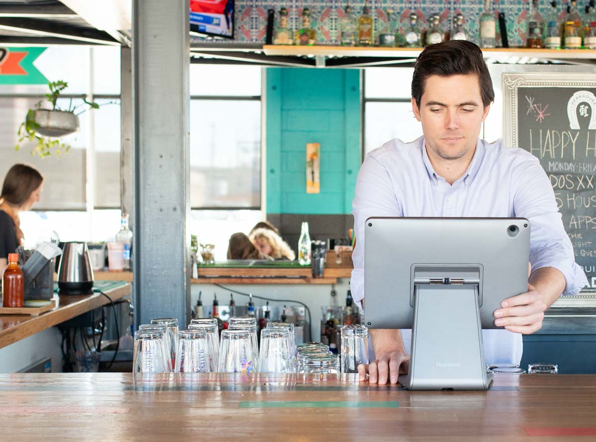 A bar staff member working on point of sale terminal